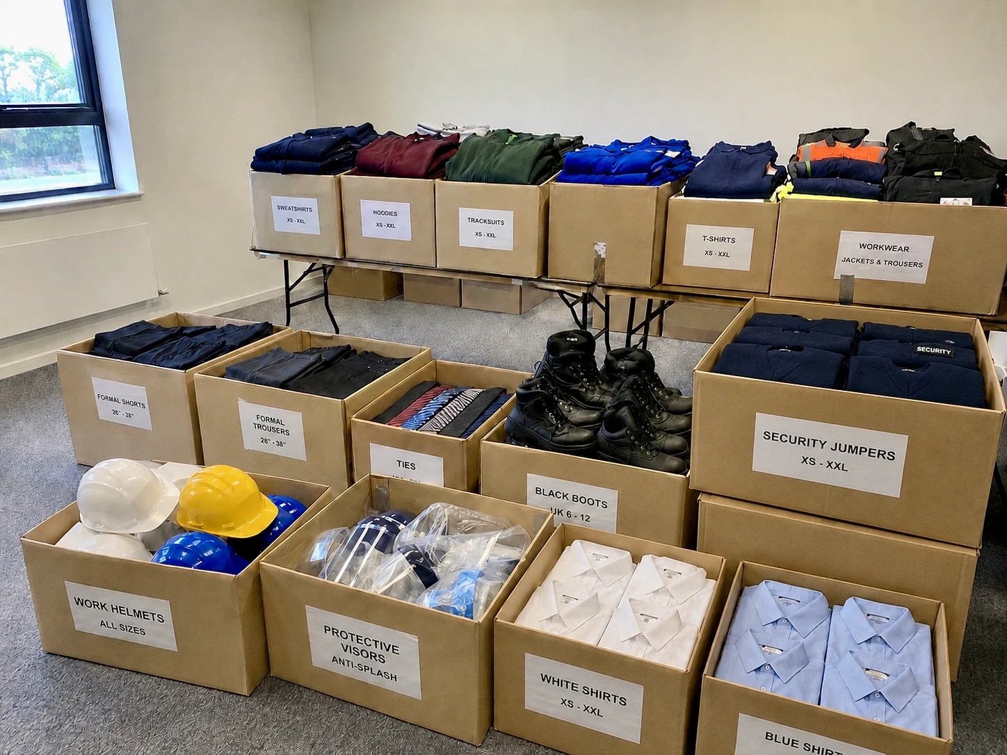 Workwear, shirts, boots and protective equipment in a sorting room